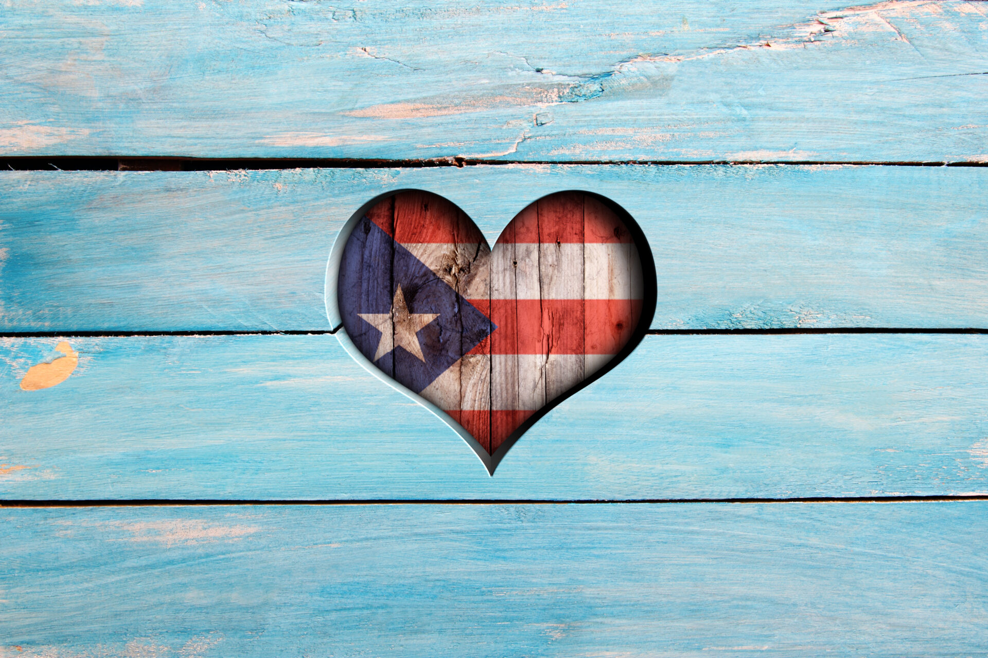 Love Puerto Rico. Heart and flag on a blue wooden board